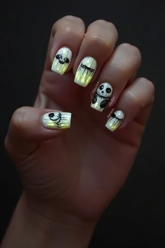 Nils Design, hallowen nails,
a cute beetlejuice themed glow in the dark nail design on a creole hand . Square nail shape
,a person's hand with white and yellow nails,skelemani,sugar skulls,skulls bo