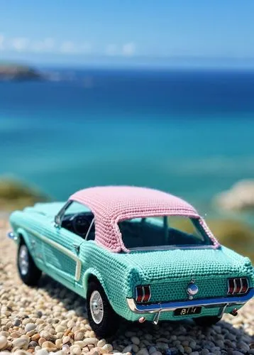 macro shot of a crochet version of a Ford Mustang retro car by the sea, crochet version, spring time, pastel colors, adorable, magical, 8k, very detailed, high resolution,a toy mustang sits on some pe