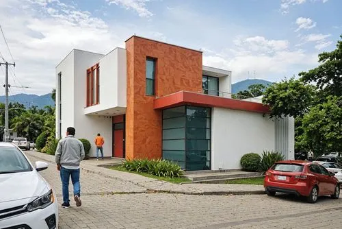 A photo-realistic rendering of a modern two-story building with a combination of white and orange colors. the building has a rectangular shape with a flat roof and large windows on both sides. The ext