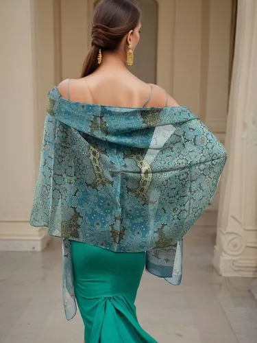 medium shot of a woman model. She is 28 years old.. She is facing away from the camera. Her long brown hair hangs down to her shoulders. She is wearing a green dress. She is wearing dangling gold earr