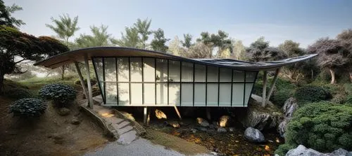a white building with large windows next to a lush green hillside,prodromal,promisor,promyamyai,prokom,tropical house,promina