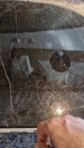 The black table gradually turns into a liquid, and when I tap it with my finger, I create waves and a whirlwind is produced.
,an image of a hand that is touching the glass,polished granite,marble pain