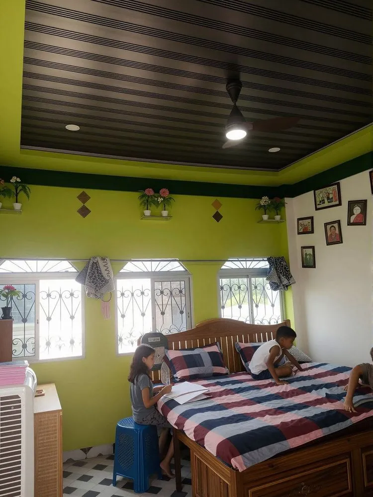 two children sit on the bed in the green bedroom