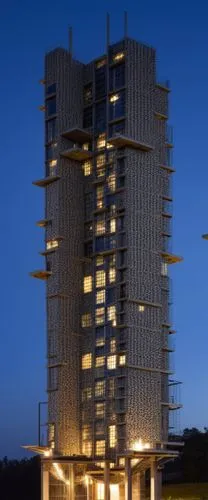 a building lit up in the night with several lights,residential tower,escala,the energy tower,renaissance tower,multistorey,chandigarh,antilla,vab,high-rise building,appartment building,impact tower,hi