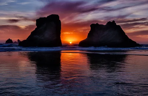 two large rock formations sitting in the ocean at sunset,the twelve apostles,twelve apostles,ruby beach,coast sunset,landscape photography,antarctic,south island,landscapes beautiful,north island,wind