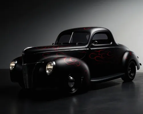 an old, black car with red flames painted on it,fiat 500,black beetle,cartoon car,fiat 600,ford cologne,mobster car,e-car in a vintage look,retro automobile,ford car,ford truck,matchbox car,street rod