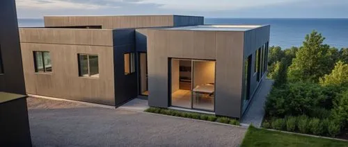 a view of some very modern looking houses near the ocean,dunes house,modern house,cubic house,modern architecture,cube house,prefab,contemporary,penthouses,cantilevered,cantilevers,holiday villa,rende