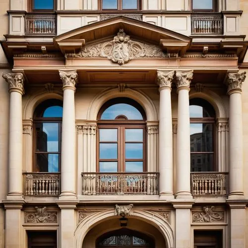 Classical architecture school, historic European-style buildings, ornate details, grand entrance, stone columns, Renaissance-inspired facade, intricate carvings, stained glass windows, sweeping stairc