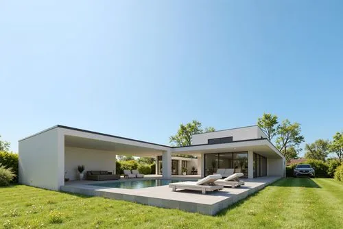 A modern, minimalist, contemporary house with a large, rectangular swimming pool in the middle of the image. the house is a two-story, white concrete structure with a black roof and large glass window