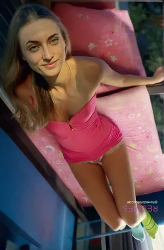 a woman in a pink swimsuit laying on a pink couch,pink chair,pink car,trampoline,lambada,gymnast,girl in car