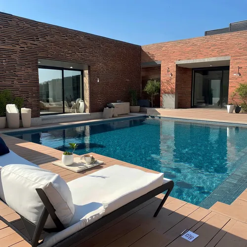 a classic courtyard villas, sustainable modern design in the middle eastern region,an empty pool with a chair, table and potted plants on it,roof top pool,outdoor pool,dug-out pool,pool house,swimming