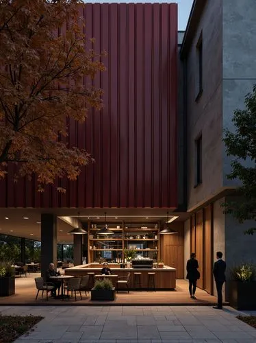 Interior of a café with a sober and warm design. The predominant colors are dark red, gray, and wood tones. The space aligns with the image and guidelines of a modern and elegant building. A wooden ba
