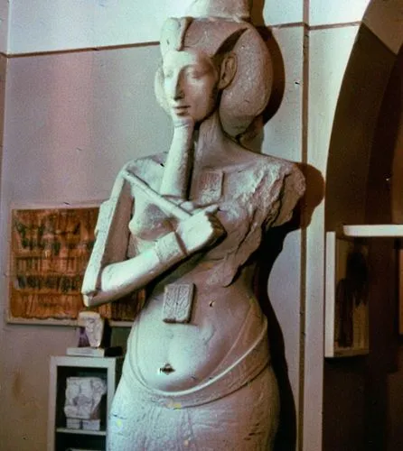 the statue has a clock in front of it,woman sculpture,pregnant statue,artist's mannequin,sculpture,statuary,sculptor