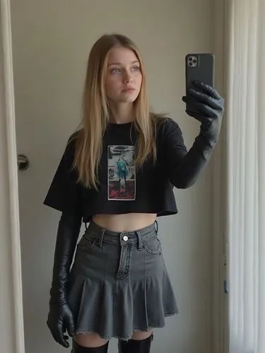 "A quick, casual frame from a selfie video where an 18-year-old blonde Russian girl with blue eyes and straight, spaghetti-like hair is filming herself. She holds her phone slightly tilted, adjusting 