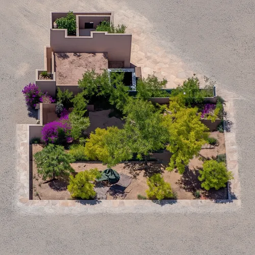 a classic courtyard villas, sustainable modern design in the middle eastern region aerial view,this aerial view shows an area that contains a house, trees, and shrubbery,landscaped,dunes house,desert 