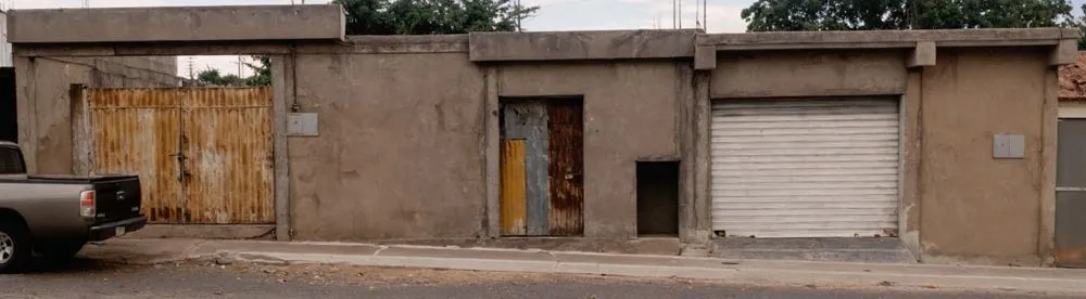 an old building with two garages on each side