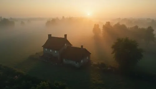 A wide aerial shot of a peaceful countryside home at dawn, soft mist in the air. Unreal Engine 5 lighting, dreamlike atmosphere.,a house on a misty day in the middle of a field,morning mist,foggy land