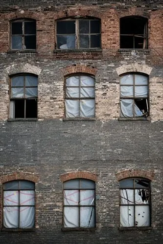 Front photo about Many broken windows on old abandoned warehouse.,several windows are open while an image of soing appears in the window,row of windows,old windows,broken windows,warehouses,old factor