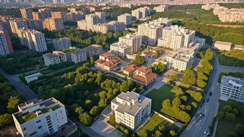 an aerial s shows the green and tall buildings, trees, and streets,residential tower,aerial view,apartment buildings,apartment blocks,building valley,blocks of houses,city view,view from above,bird's-