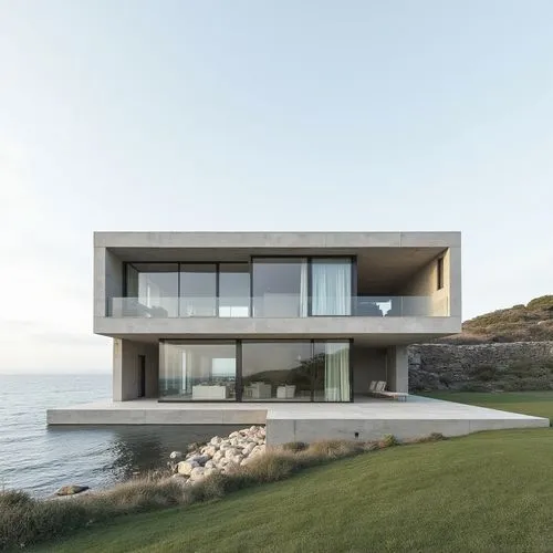 on the sea,modern house on coast side overlooking ocean during sunny day,dunes house,modern house,modern architecture,beach house,house by the water,siza,snohetta,cubic house,oceanfront,cantilevered,c