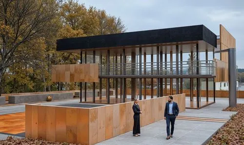 a man and woman standing in front of a building that is built from wood,cubic house,modern house,timber house,cube house,modern architecture,modern office,shipping container,mirror house,cube stilt ho