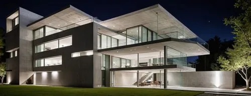 an extravagant modern home with glass windows at night,cubic house,modern architecture,cube house,glass facade,modern house,contemporary,cantilevers,cantilevered,glass facades,residential,structural g