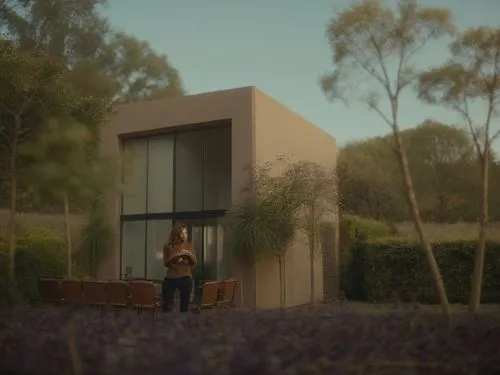 there is a woman standing on the balcony of a building,modern house,dunes house,mid century house,smart house,cubic house,cube house,house shape,house,model house,residential house,garden elevation,wo