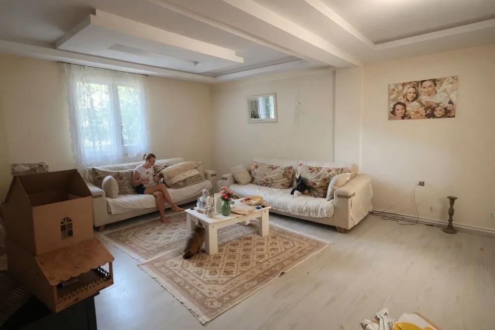 a man sitting on the couch inside of a house