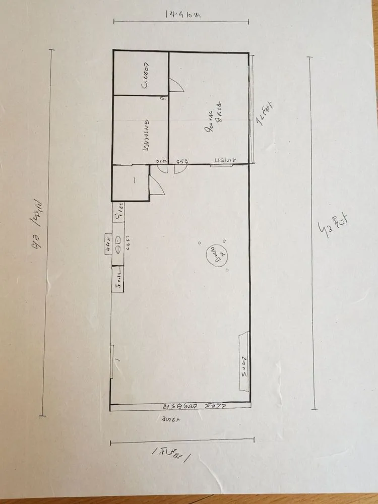 a plan is on a wood surface with blue ink