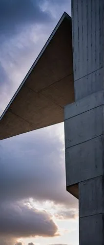 Subtractive architecture, modern building, sleek lines, geometric shapes, brutalist design, concrete material, rough texture, minimalist decoration, urban cityscape, metropolitan atmosphere, cloudy sk