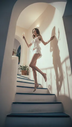 Low angle and sided view. Over exposed and well framed and well composed photo. It shows a lady walking up the stairs with a champagne cup in her hand. 
Shes wearing a small babydoll pijama and has a 
