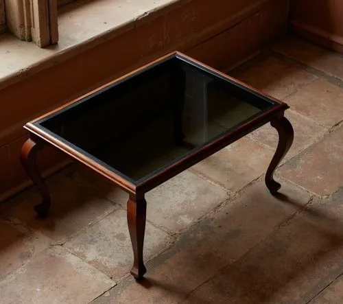 A vintage wooden coffee table with a black smoked glass top, softly illuminated by warm, ambient lighting, nestled in a cozy reading nook under a large, detailed arched window, with a slight dusting o