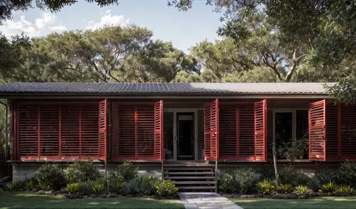 red louver shutters maintaining the landscape,garden design sydney,timber house,landscape designers sydney,landscape design sydney,mid century house,inverted cottage,dunes house,holiday home,corten st