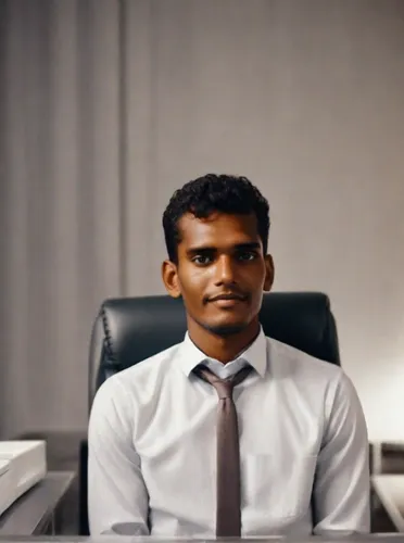 A luxury business beautiful boy sit in office in amerika ,blur office background,maldivian rufiyaa,office worker,social,administrator,stock exchange broker,maldives mvr,black businessman,benagil,accou
