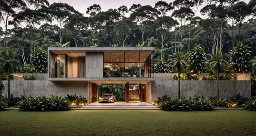 vivienda moderna de dos niveles, con muebles que se vean en segundo nivel, ventanales de cristal, muros de piedra a vista, vegetacion, jardin, pavimentos, iluminacion exterior e interior, rampa a la e