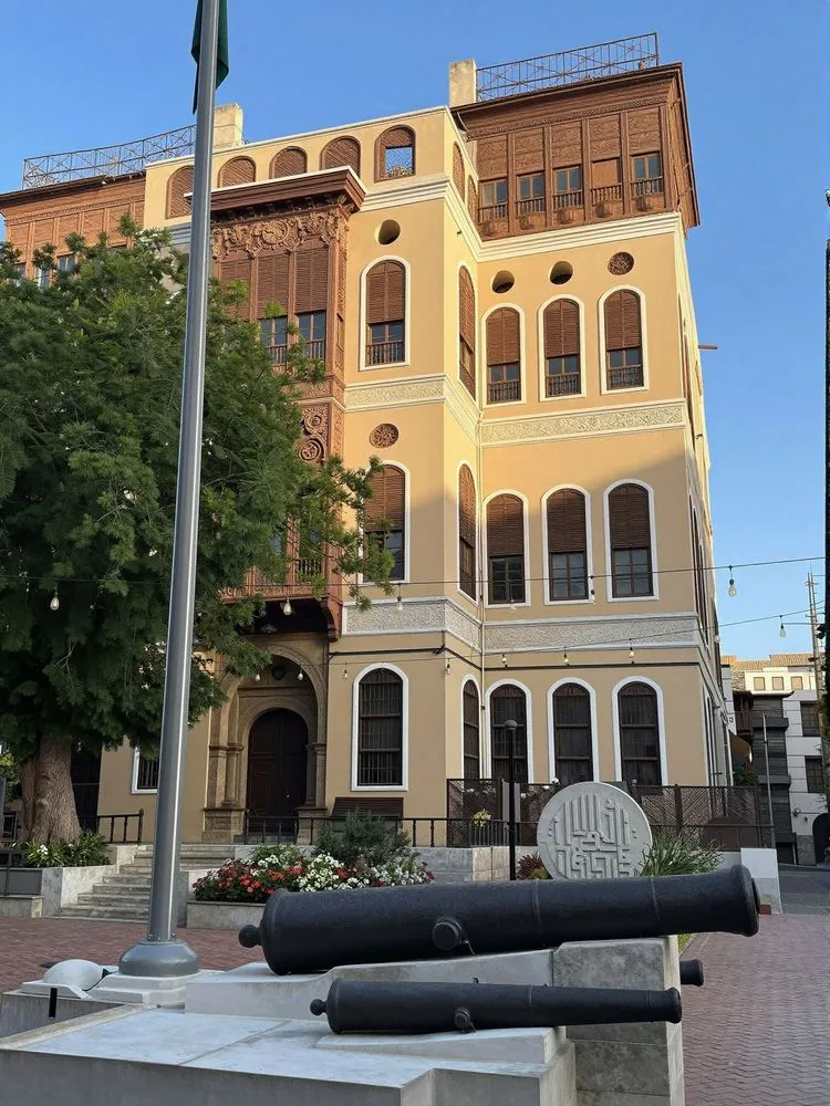 cannon sitting on concrete outside of an old building