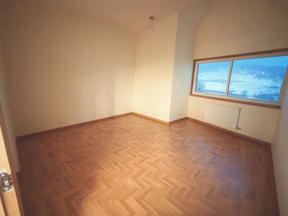 an empty room with a very big window