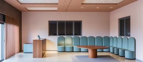 international kids school reception area n waitng area ,a room with some chairs around a table and a podium in front of it,examination room,therapy room,conference room,treatment room,lecture room,doc