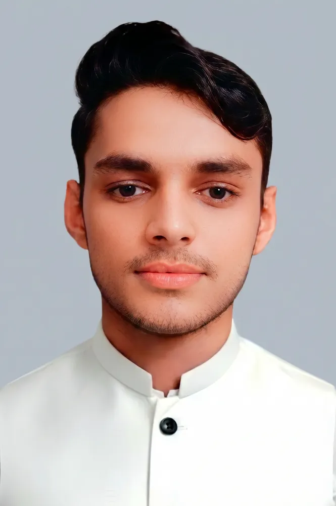 man with dark brown hair looking into the camera