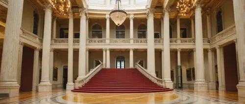 National Gallery, neoclassical architecture, grandiose columns, marble floors, high ceilings, intricate moldings, large staircase, ornate chandeliers, natural light pouring in from dome ceiling, dayti