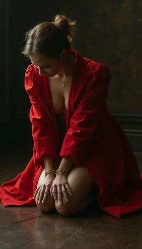 The queen lowers her head in despair, her golden handcuffs glinting coldly under the dim light. The weight of her defeat is visible in her posture, her vibrant red puffy open, she naked under puffy , 
