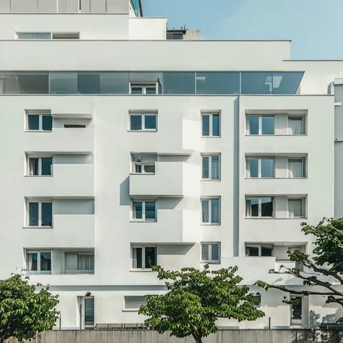 Modern architecture, minimalist design, office building,a tall white building with several balconies,plattenbau,immobilien,appartment building,bahru,rigshospitalet,immobilier
