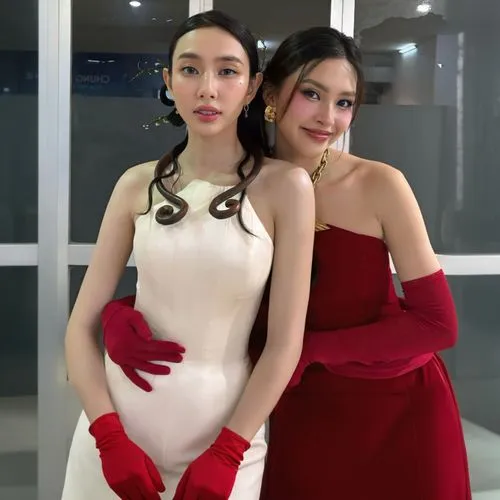 two women wearing red gloves posing for the camera,handmaidens,handmaiden,red velvet,goddesses,priestesses,debutantes,ballgowns,handmaids,empresses,sisters,angel and devil,heiresses,pretty women,model