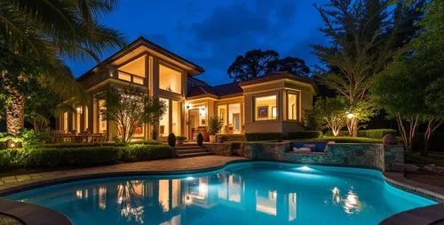 pool with water feature in front of a beautiful house at night,florida home,pool house,luxury home,beautiful home,mansion,dreamhouse,holiday villa,luxury property,beach house,crib,tropical house,mansi