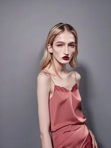 Shyanne with her characteristic long nose bridge at the model shoot,a woman in pink is posing for the camera,allude,gold-pink earthy colors,french silk,menswear for women,editorial,satin,pale,female m