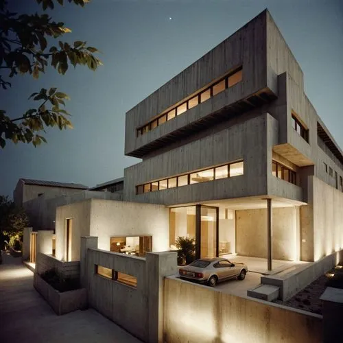 a modern style house at dusk with a driveway,modern house,modern architecture,cube house,dunes house,cubic house,contemporary