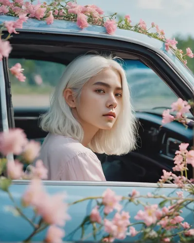 A girl with white hair sitting in car filled with flowers, art by Rinko Kawauchi, in the style of naturalistic poses, vacation dadcore, youthful energy, a coolexpression, body extensions, flowers in t