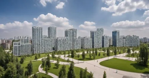 The residential buildings are located in front of the large park. They have large windows that allow the park view. The park includes small lake in it. The buildings are modern style. Blue sky with so