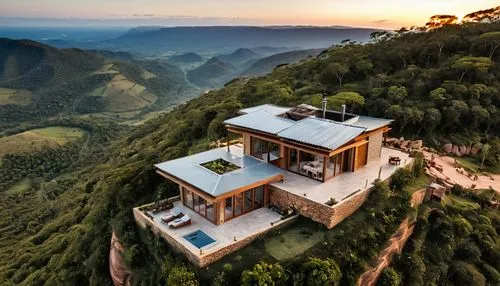 Generate a realistic image of a bioconstructed tiny house with rammed earth and stone walls, ceramic tile roof, burnt cement floor. Some walls are made of stone, with abundant use of glass and wood el