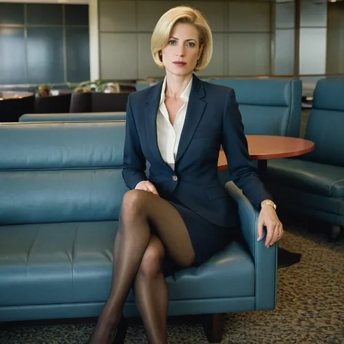 A smartly dressed businesswoman, age around 40, at an airport lounge, expensive skirt suit, pantyhose, blonde short hair,business woman,businesswoman,secretary,flight attendant,business girl,senator,c
